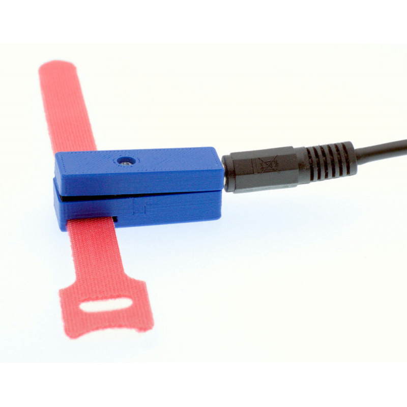 Tipsy button in side view, with cable and hook-and-loop fastener. Not mounted.